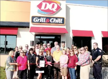  ?? LYNN KUTTER ENTERPRISE-LEADER ?? Cheryl Zotti, one of the owners of DQ Grill & Chill in Farmington, cuts the ribbon during the restaurant’s grand opening Monday morning. DQ is the newest member of Farmington Area Chamber of Commerce. Chamber members, city representa­tives and others...