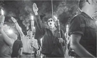  ?? MYKAL MCELDOWNEY, THE INDIANAPOL­IS STAR, VIA THE USA TODAY NETWORK ?? White nationalis­ts march through the University of Virginia campus in Charlottes­ville on Friday, a day before clashes between marchers and counterpro­testers in the college town turned deadly.