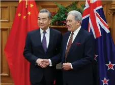  ?? ?? Wang Yi shakes hands with Winston Peters during a bilateral meeting at Parliament in Wellington. Wang says China will work with New Zealand to maintain peace and stability in the region and the world– AFP photo