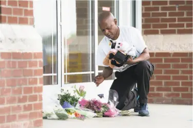  ?? Sean Rayford / Getty Images ?? Jack Logan, founder of Put Down the Guns Young People, places stuffed animals and flowers outside of a Rock Hill, S.C., hospital after the fatal shooting of a wellknown doctor and five others by Adams.