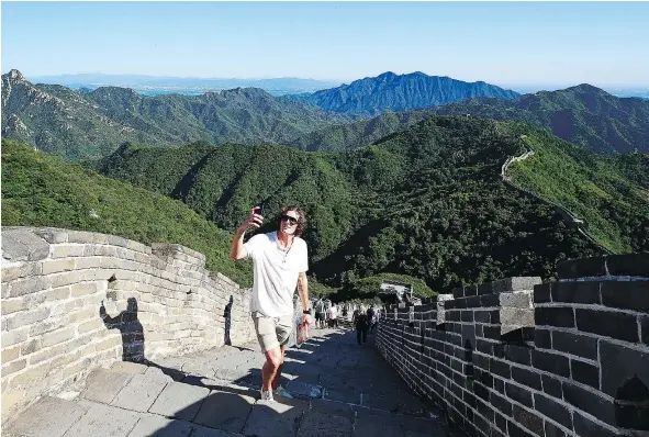  ?? — GETTY IMAGES ?? The Vancouver Canucks’ Loui Eriksson stops to take a selfie while climbing the Great Wall of China during a break between two exhibition games against the Los Angeles Kings. Another B.C. team played hockey in China 44 years ago.