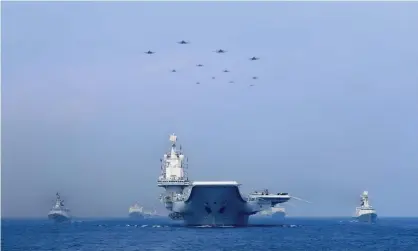  ??  ?? Warships and fighter jets of the Chinese People's Liberation Army (PLA) navy take part in a military display in the South China Sea. The US, UK and Australia have set up Aukus, a trilateral security pact Photograph: China Stringer Network/Reuters