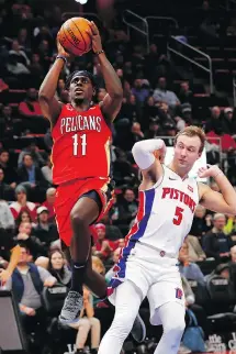  ?? PAUL SANCYA/THE ASSOCIATED PRESS ?? Pelicans guard Jrue Holiday goes up for a shot against the defence of Pistons guard Luke Kennard in Detroit on Sunday. Holiday had 37 points in a 116-108 Pelicans’ victory.