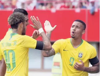  ?? AP ?? Brazil’s Gabriel Jesus (right) celebrates with teammates after scoring his side’s opening goal during a friendly match between Austria and Brazil.
