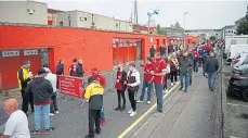  ??  ?? Supporters waiting patiently to enter the stadium.