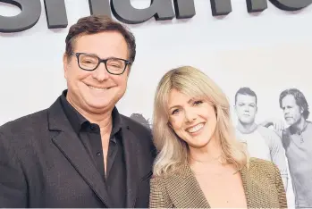  ?? CHRIS DELMAS/GETTY-AFP ?? The late actor Bob Saget and his wife, Kelly Rizzo, in Hollywood on March 6, 2019. Saget died most likely of head trauma after a fall in his hotel room, a Florida medical examiner said.