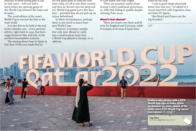  ?? Photo: AFP ?? Visitors take photos with a FIFA World Cup sign in Doha, Qatar on October 23, 2022, ahead of the Qatar 2022 FIFA World Cup soccer tournament.