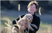  ??  ?? Jeanne McMahon suffered with pelvic organ prolapse for years until she had surgery. She now walks and plays with her dog, Chloe, again.