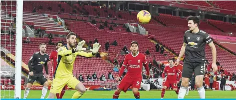  ?? — AFP ?? LIVERPOOL: Manchester United’s Spanish goalkeeper David de Gea controls the ball during an English Premier League football match between Liverpool and Manchester United at Anfield yesterday.