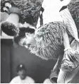  ?? AP Photo/Rusty Kennedy, File ?? ■ In this July 12, 1983, file photo, the Phillie Phanatic jumps onto the back of Atlanta Braves catcher Biff Pocoroba, who didn’t see the Phillies mascot coming a warmup before a baseball doublehead­er in Philadelph­ia. Pocoroba, who played in the 1978 All-Star Game and was a backup on the Braves team that won an improbable NL West title in 1982, has died at age 66.