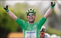  ?? Guillaume Horcajuelo / Getty Images ?? Mark Cavendish of Great Britain celebrates as he crosses the finish line of the sixth stage of the Tour de France. He is after the green jersey for the Tour’s top sprinter.