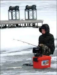  ??  ?? A young angler braves the cold and ice during the 2014 Burbot Classic.