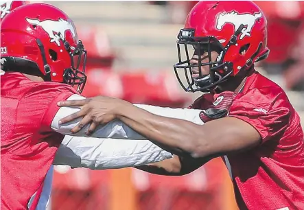  ?? CRYSTAL SCHICK/ CALGARY HERALD ?? Linebacker Brandon Harper, right, arrives at the Stampeders’ training camp with a reputation of being a big hitter.