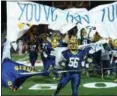  ?? DAVID TURBEN — THE NEWS-HERALD ?? Kirtland takes the field before its 44-0 Division VI state semifinal win over Nelsonvill­e-York to improve to 14-0 on the season.