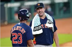  ?? Associated Press ?? ■ Houston Astros pitcher Justin Verlander, right, talks with Michael Brantley (23) after throwing during a simulated game Thursday in Houston.