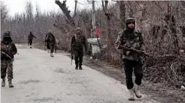  ?? — H.U. NAQASH ?? Army jawans patrol a road near the encounter site in Shopian district on Thursday.