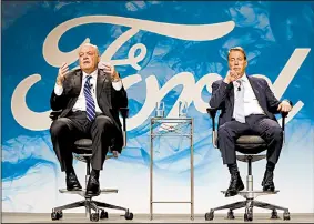  ?? AP/PAUL SANCYA ?? Jim Hackett (left), Ford Motor Co.’s new CEO, speaks at an event with Chairman William Ford Jr. on Monday in Dearborn, Mich.