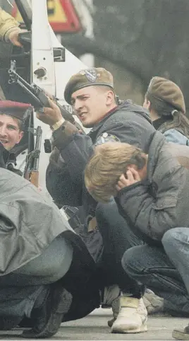  ??  ?? A soldier returns fire in Sarajevo as he and civilians come under fire from snipers, main; Aleksandar Hemon, top right