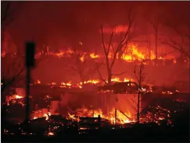  ?? DAVID ZALUBOWSKI — THE ASSOCIATED PRESS ?? Homes burn as a wildfire rips through a developmen­t near Rock Creek Village, Thursday, near Broomfield, Colo. An estimated 580 homes, a hotel and a shopping center have burned and tens of thousands of people were evacuated in wind-fueled wildfires outside Denver, officials said Thursday evening.