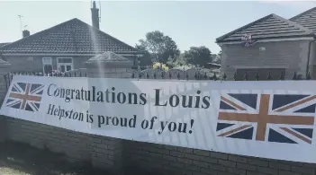  ??  ?? The banner in Helpston welcoming Louis Smith home