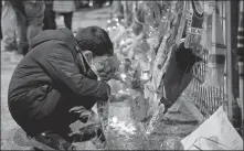  ?? AP ?? A boy lights a candle on Wednesday outside Stadio San Paolo in Naples, where the late great Diego Maradona spent the most successful period of his career with Serie A club Napoli.