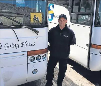  ??  ?? Bus driver Tony O’Brien beside the vandalised bus with its broken windscreen wiper visible.