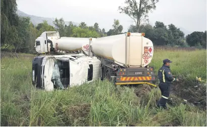  ?? Picture: Refilwe Modise ?? WRONG ROUTE. A first responder inspects the scene of an accident involving a truck and a taxi in Little Falls, west of Johannesbu­rg, yesterday. According to paramedics, there were no fatalities.