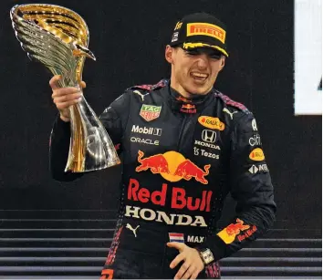  ?? — AP ?? Red Bull driver Max Verstappen celebrates after becoming Formula 1 champion in Abu Dhabi on Sunday.