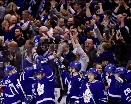  ??  ?? In this April 8 file photo, Toronto Maple Leafs celebrate an empty-net goal by center Auston Matthews against the Pittsburgh Penguins during the third period of an NHL hockey game, in Toronto. Canada is back in the Stanley Cup playoffs. The buzz is...