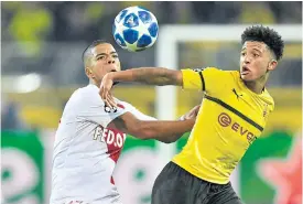  ??  ?? Dortmund’s Jadon Sancho, right, vies with Monaco’s Benjamin Henrichs.