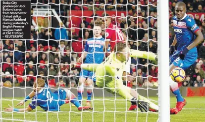  ??  ?? Stoke City goalkeeper Jack Butland saves from Manchester United striker Marcus Rashford during yesterday’s English Premier League match at Old Trafford. – REUTERSPIX