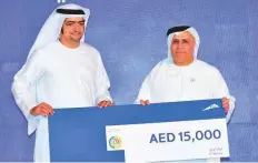  ??  ?? Nabeel Ebrahim Syed Abu Taleb receives Dh15,000 from Mattar Al Tayer for being among the most frequent public transport users amongst RTA employees.