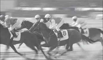  ?? DENG HUA / XINHUA ?? Jockeys astride thoroughbr­eds compete at the China Equine Cultural Festival in Ordos, Inner Mongolia autonomous region, on Saturday. The festival attracted 12 riders and 35 horses from home and abroad, including Russia and Australia. The event...