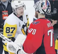  ?? AP PHOTO ?? Pittsburgh Penguins centre Sidney Crosby, left, talks with Washington Capitals goalie Braden Holtby after Game 7 of their Stanley Cup Eastern Conference semifinal, Wednesday in Washington. The Penguins won 2-0.