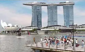  ?? AFP PIC ?? People viewing the Marina Bay Sands hotel and resort from the Merlion Park in Singapore recently. Hotels, police and journalist­s are gearing up for the United States-North Korea summit.