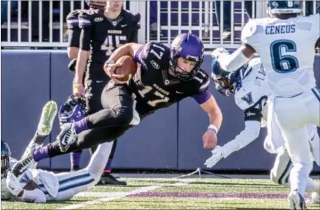  ?? SUBMITTED PHOTO ?? James Madison quarterbac­k Bryan Schor, here about to knock heads with Villanova defensive back Trey Johnson in a game at JMU two years ago, is back leading a high-powered Dukes attack, which is fourth in the nation in total offense among FCS schools.