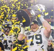  ?? AP FILE ?? Last year’s Pinstripe Bowl resulted in Iowa and right tackle Sean Welsh celebratin­g a victory over Boston College. The Hawkeyes are in this year’s Outback Bowl against Mississipp­i State.