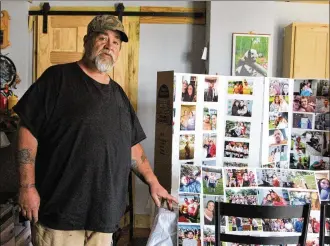  ?? HASAN KARIM / STAFF ?? Junie Whitt points to a collage of pictures of his two sons Robert and Timothy Whitt, as well as Timothy’s longtime partner Amber Whitt and her son Immanuel Burchnell. All four lost their lives in a fatal crash in Champaign County.