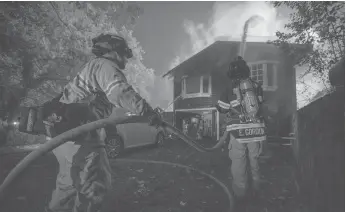  ?? Bay Area News Group/tns ?? Firefighte­rs battle a fire at a home along Tucker Road in Calistoga, CA, on Friday, Oct. 2, 2020.