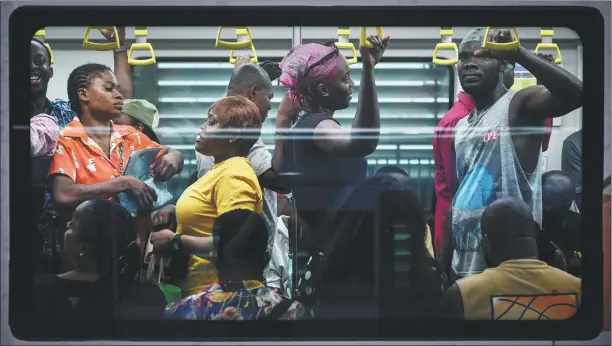  ?? ?? Passengers on board the Lagos Rail Mass Transit Blue Line connecting Mile 2 to Marina. The electric line has been providing passengers with a speedy journey since September.