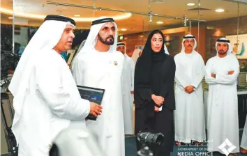  ?? Courtesy: Dubai Media Office ?? Shaikh Mohammad being briefed about the Media Briefings Programme in the presence of Mona Al Merri during a visit to the Government of Dubai Media Office headquarte­rs yesterday.