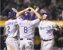  ?? Ezra Shaw / Getty Images ?? Cam Gallagher (36) is congratula­ted by Alcides Escobar and Mike Moustakas after hitting a sixth-inning grand slam.