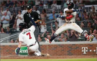  ?? AP PHOTO JOHN BAZEMORE ?? Atlanta Bravess Ronald Acuna Jr. reacts as Dansby Swanson (7) scores on a Julio Terheran base hit during the fifth inning of a baseball game against the Colorado Rockies on Thursday, Aug. 16, 2018, in Atlanta. The Rockies won 5-3.