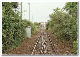  ?? PAUL CLIFTON. ?? The former alignment to the harbour wall and cross-channel ferry terminal, with tracks about to be replaced by a cycleway and pedestrian path… although the red signal shines on.