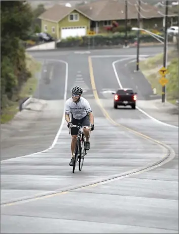  ?? The Maui News / MATTHEW THAYER photo ?? Waiohuli resident Richard Sellona pedals his way up steep Ka‘amana Street Wednesday afternoon. Sellona said the climbs in his neighborho­od, including an 11-percent grade on Keanuhea Street, were part of his training for the 60-mile Pedal Imua bike ride fundraiser for Imua Family Services set for Dec. 12. The Keokea homestead area Sellona was riding in and others in the county could be exempt from certain water requiremen­ts under a bill before the Maui County Council.