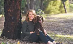  ?? Picture: GLENN FERGUSON ?? MORE THAN A JOB: Palliative care nurse Melanie Davies with her dog Eddie.