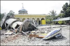  ?? GETTY IMAGES ?? Houses of worship destroyed by the earthquake of 6.5 magnitude on Wednesday in Pidie, Aceh Province, Indonesia. The earthquake killed at least 97 people and caused dozens of buildings to collapse. Many people are feared trapped under the rubble.
