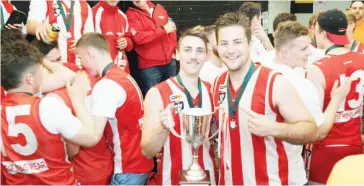  ??  ?? Trafalgar players Lachie Farrell and Ben Doran celebrate with the premiershi­p cup.