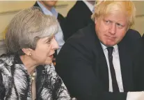  ?? LEON NEAL/POOL VIA THE ASSOCIATED PRESS ?? British Prime Minister Theresa May sits with Foreign Secretary Boris Johnson as she holds the first Cabinet meeting of her new team Monday at 10 Downing Street in London.