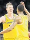  ?? KIRTHMON F. DOZIER/TNS ?? Michigan’s Moritz Wagner, left, and Charles Matthews celebrate their team’s 69-57 victory.